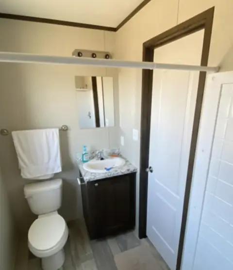 Private bath of a 16×76 4-suite full-kitchen unit