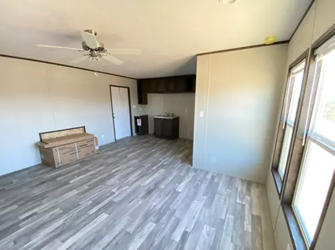 Suite living area of a 16×76 4-suite full-kitchen unit