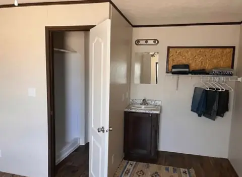 Private bath of a 16×76 5-bed crew unit with shared kitchen