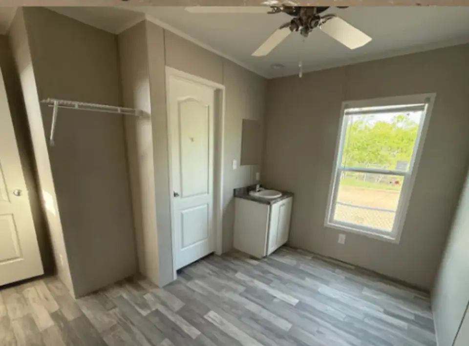Bedroom of a 16×76 HUD-code 5-bed unit with shared kitchen