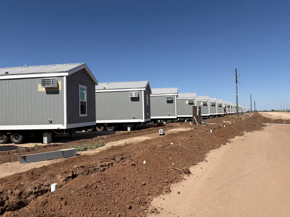 Row of factory-built crew housing units on a Texas job site