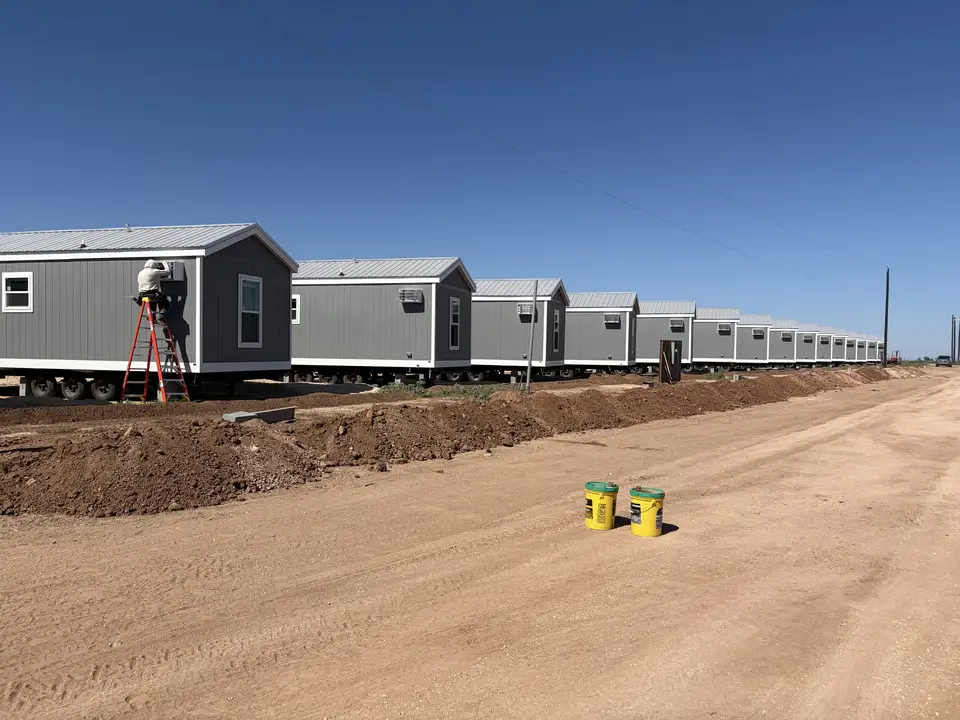 Row of factory-built crew housing units on a Texas job site