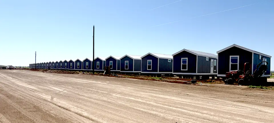 Row of factory-built crew housing units on a Texas job site