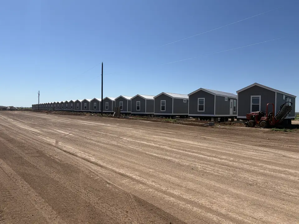 Row of factory-built crew housing units on a Texas job site