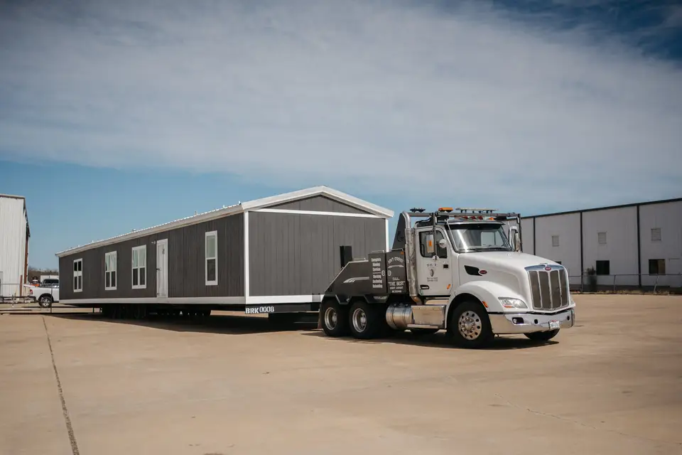 Housing unit loaded on a truck for delivery