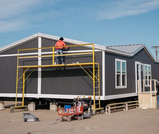 Housing unit being built and set by a Texas factory crew
