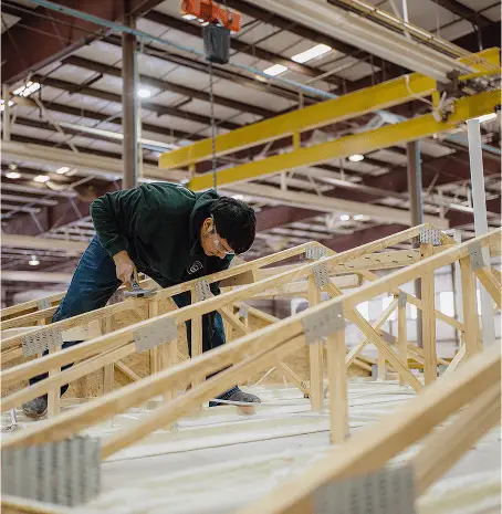 Housing unit being built and set by a Texas factory crew